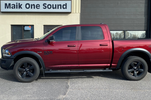 Tinted vehicle in front of Local Shop